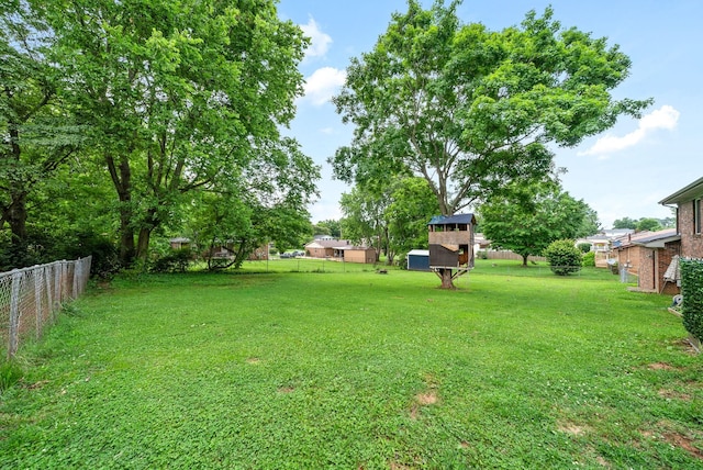 view of yard featuring fence and an outdoor structure