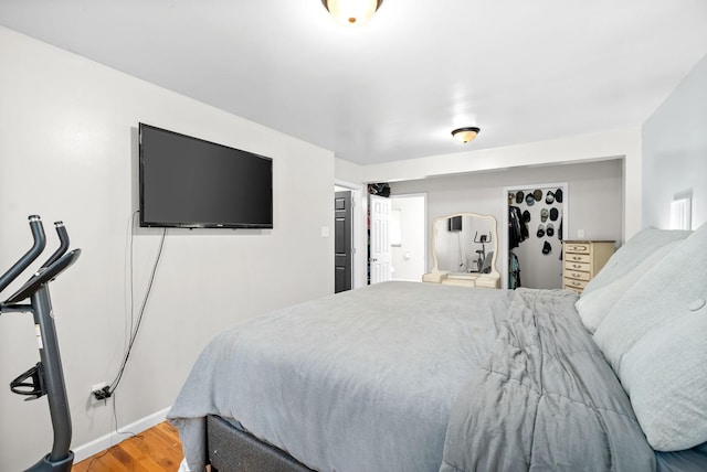 bedroom with baseboards and light wood-style floors