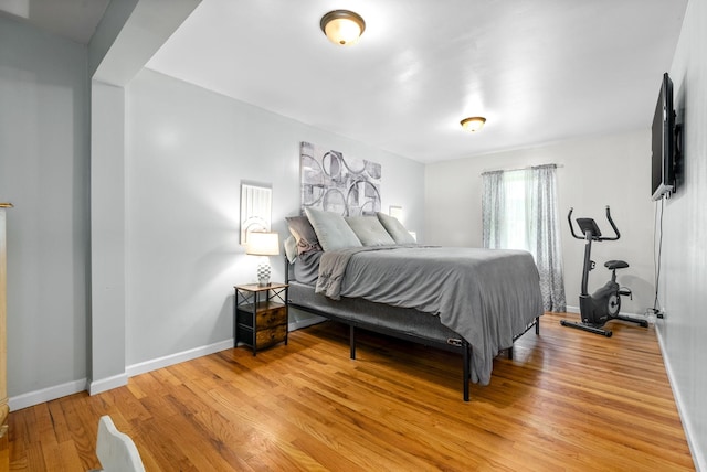 bedroom with light wood-style floors and baseboards