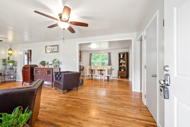 living room with ceiling fan and light wood-style flooring