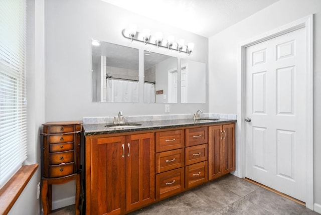 bathroom with double vanity, tile patterned flooring, a sink, and a shower with curtain