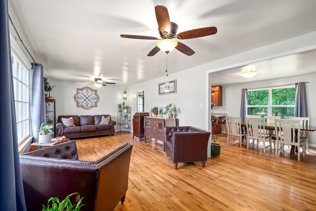 living room with light wood-style flooring and a ceiling fan