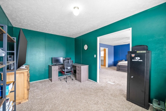 carpeted office space featuring a textured ceiling