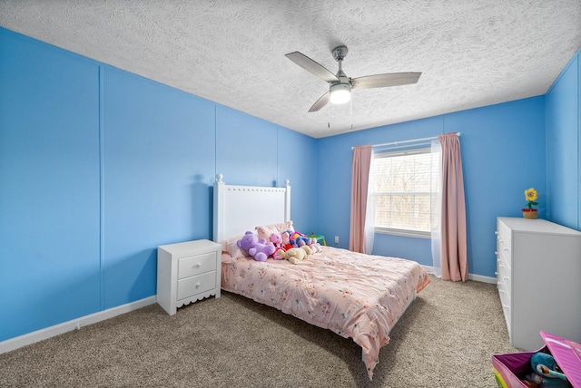 carpeted bedroom featuring ceiling fan, baseboards, and a textured ceiling