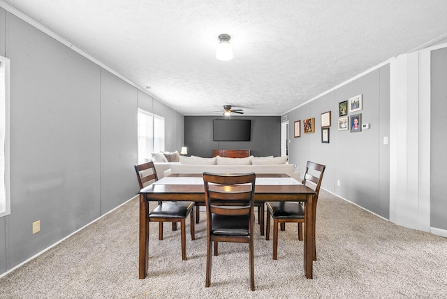 dining area with light carpet, crown molding, and a textured ceiling