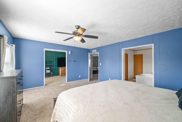 carpeted bedroom with visible vents, ceiling fan, a textured ceiling, and ensuite bathroom