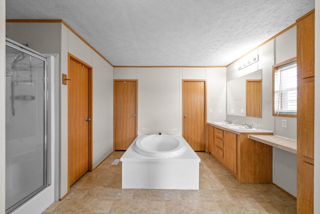 bathroom with a garden tub, crown molding, a shower stall, and vanity