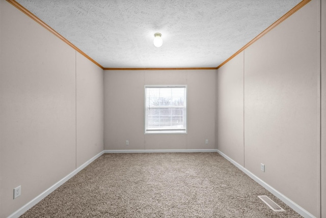 unfurnished room with visible vents, ornamental molding, carpet flooring, a textured ceiling, and baseboards