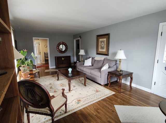 living room with baseboards and wood finished floors