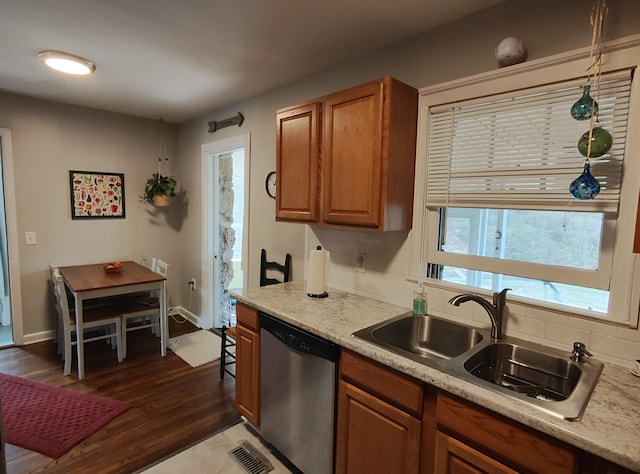 kitchen with dark wood-style flooring, a sink, dishwasher, tasteful backsplash, and brown cabinetry