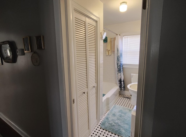 bathroom with shower / tub combo and a closet