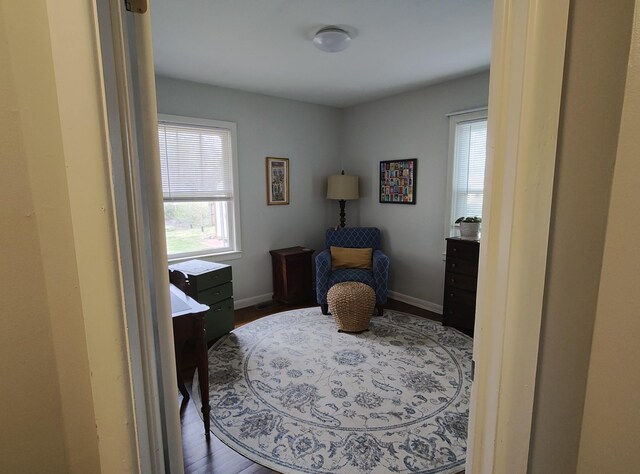 living area featuring baseboards and wood finished floors