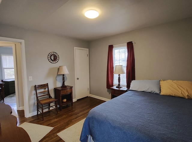 bedroom featuring wood finished floors and baseboards