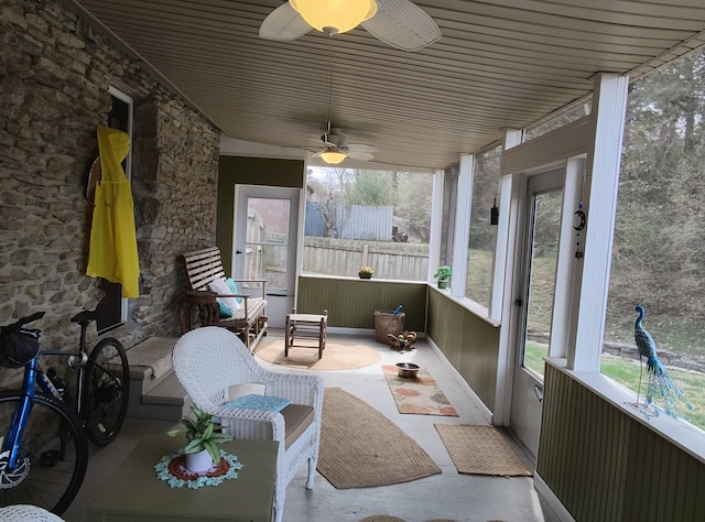 sunroom featuring a ceiling fan