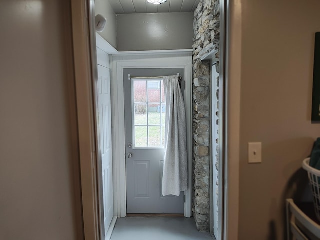 doorway to outside featuring concrete floors