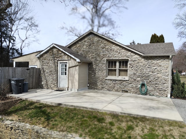 rear view of house with a patio area and fence