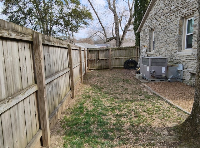 view of yard featuring cooling unit and a fenced backyard