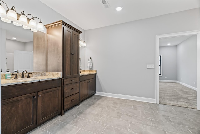 full bath with recessed lighting, a sink, visible vents, baseboards, and double vanity