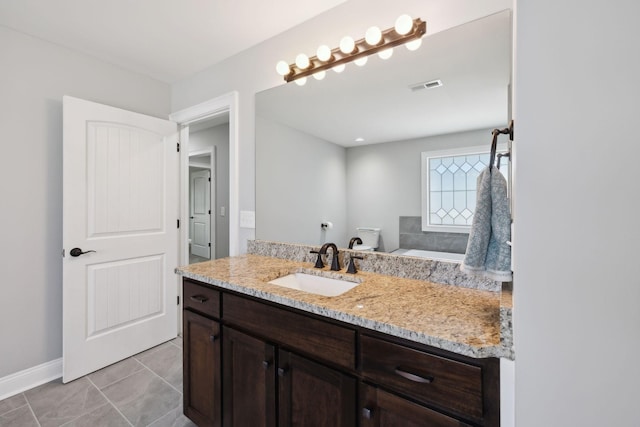 bathroom featuring tile patterned flooring, visible vents, baseboards, and vanity