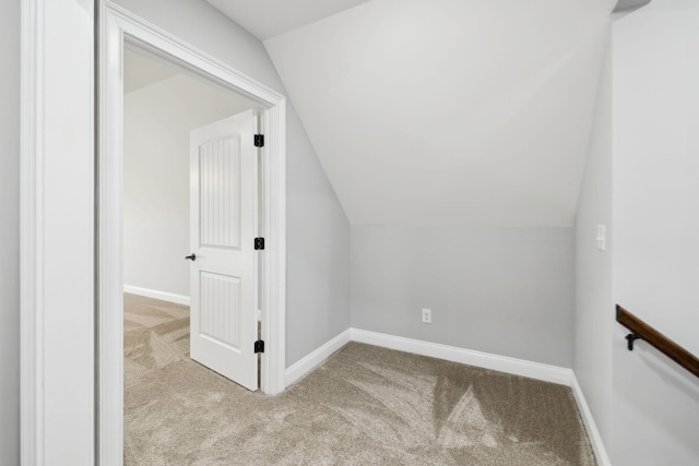 additional living space with lofted ceiling, carpet flooring, and baseboards