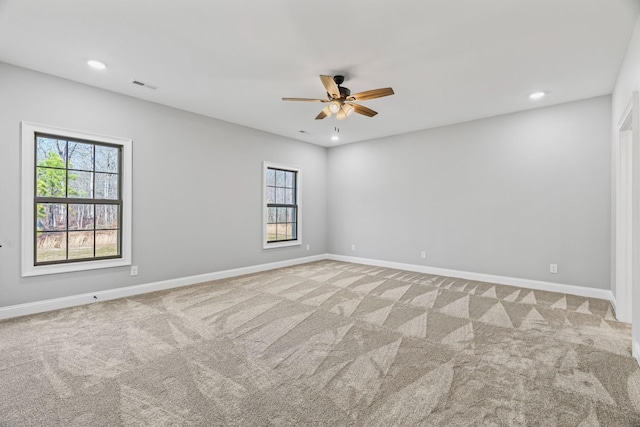 spare room featuring carpet floors, baseboards, visible vents, and recessed lighting