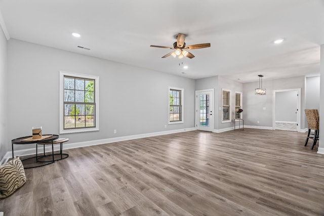 unfurnished living room with baseboards, visible vents, wood finished floors, and recessed lighting