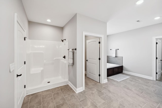 full bathroom featuring baseboards, visible vents, a shower, a garden tub, and recessed lighting