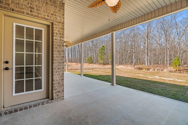 view of patio / terrace with a forest view and ceiling fan