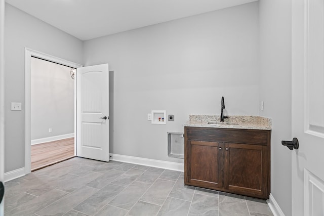 clothes washing area featuring washer hookup, a sink, electric dryer hookup, and baseboards