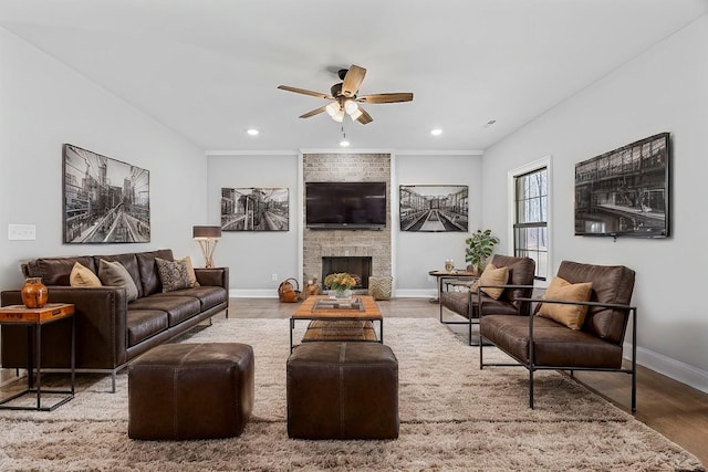 living room featuring a large fireplace, baseboards, ceiling fan, wood finished floors, and recessed lighting