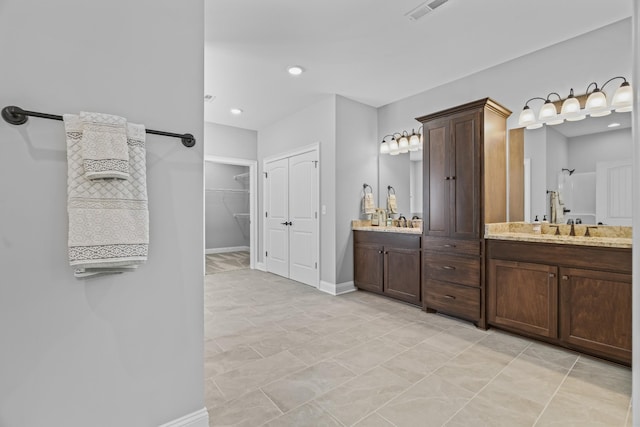 full bath featuring recessed lighting, visible vents, vanity, and baseboards