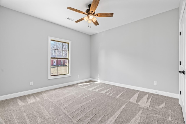 empty room featuring carpet, visible vents, ceiling fan, and baseboards