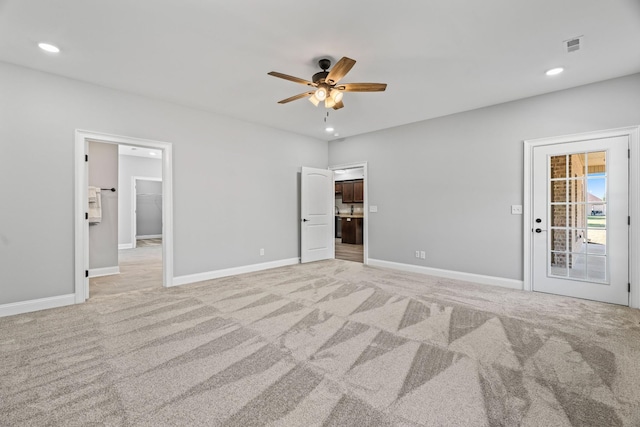 unfurnished bedroom with recessed lighting, light colored carpet, and baseboards