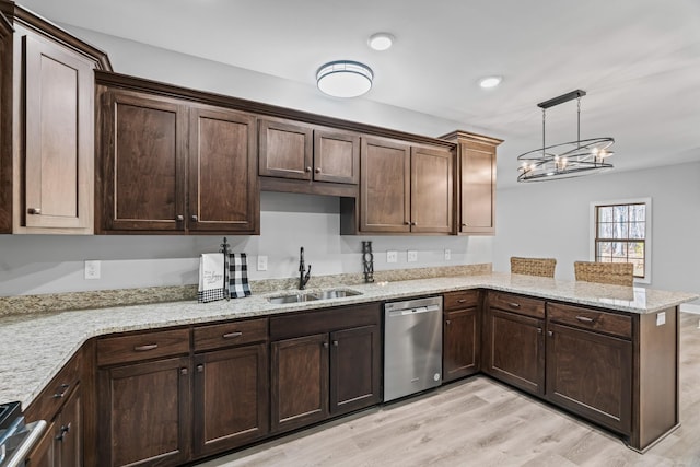 kitchen featuring stainless steel appliances, a sink, a peninsula, and dark brown cabinets