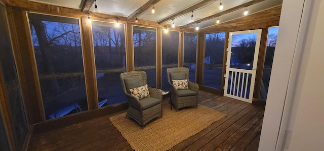 sunroom / solarium featuring lofted ceiling with beams