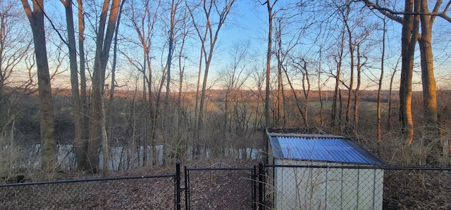 yard at dusk featuring fence