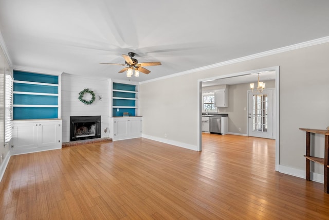 unfurnished living room with a large fireplace, baseboards, ornamental molding, and light wood-style floors