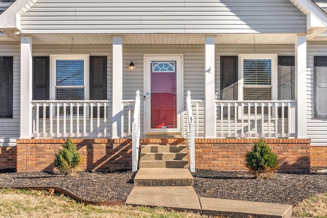 view of exterior entry with covered porch