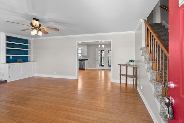 unfurnished living room featuring light wood finished floors, stairway, a ceiling fan, and crown molding