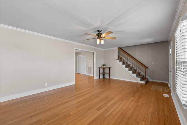 interior space with light wood-type flooring, baseboards, stairway, and crown molding