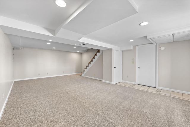 finished below grade area featuring carpet, stairway, and baseboards