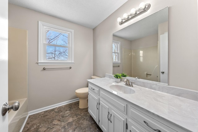 full bathroom featuring a textured ceiling, vanity, toilet, and baseboards