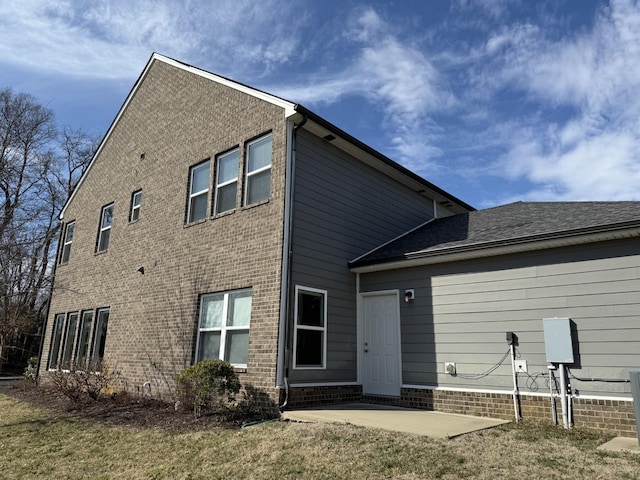 rear view of property with a yard and a patio