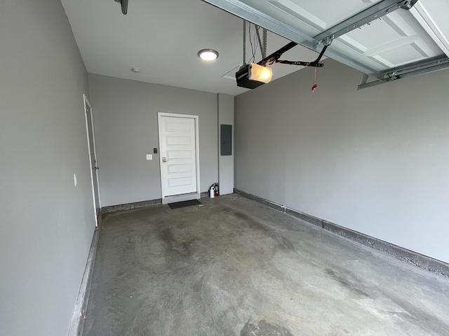 garage with baseboards, electric panel, and a garage door opener