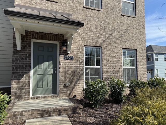 entrance to property with brick siding