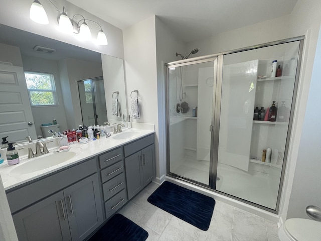 bathroom featuring a sink, a shower stall, and toilet