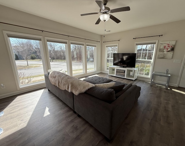 living room featuring ceiling fan, dark wood finished floors, and baseboards