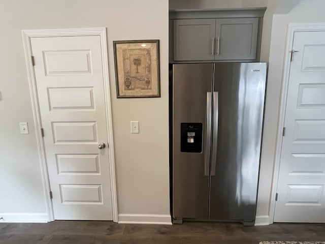 kitchen with baseboards, dark wood-style flooring, stainless steel refrigerator with ice dispenser, and gray cabinetry