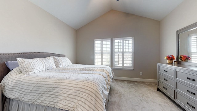 bedroom with light carpet, multiple windows, baseboards, and lofted ceiling