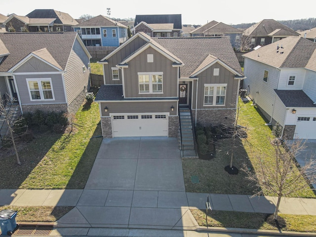 craftsman house featuring a garage, concrete driveway, stone siding, a residential view, and board and batten siding